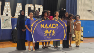  students holding banner 